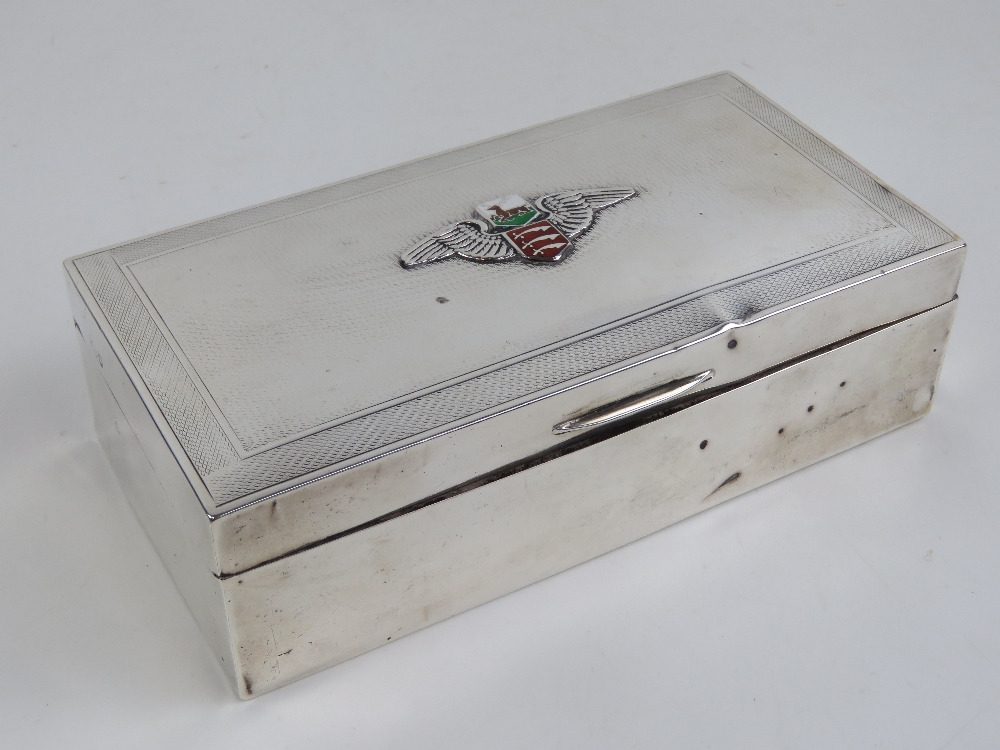 A HM silver cigar box having winged enamelled crest upon depicting stag over triple swords for