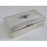A HM silver cigar box having winged enamelled crest upon depicting stag over triple swords for