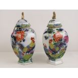 A pair of Cartonware hand painted hexagonal ginger jars with covers.