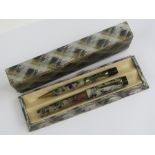 A vintage marbled 'self-filler' fountain pen with 14ct gold nib, with matching propelling pencil,