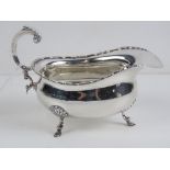 A HM silver sauce boat raised over three feet and standing 10cm high, hallmarked Birmingham 1928, 4.