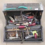 A vintage tool box opening to reveal a quantity of vintage tools within.
