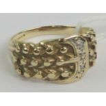 A 9ct gold ring in the form of a belt and buckle, set with two small diamonds, hallmarked 375,