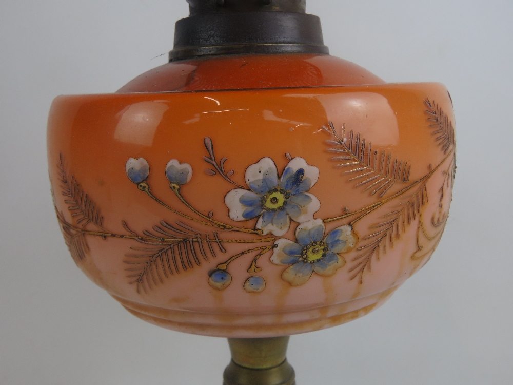 A 19th century oil lamp having brass base, orange glass reservoir with floral decoration, - Image 2 of 5