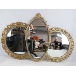 Three assorted mirrors including an oval and circular bevel edged mirrors, and a bulls eye mirror.