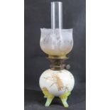 A 19th century oil lamp, the spherical base with Oriental decoration, glass feet,