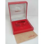 A red leatherette Omega wristwatch presentation box, 10cm sq.