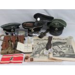 A quantity of assorted militaria including; three reproduction WWII German caps, a British cap,