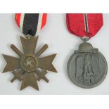 A WWII German 1939 cross with swords medal, together with another WWII German medal Imosten.