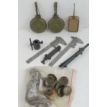 A quantity of WWII German Kleinan waffen werkzegatz measuring tools, an Afrika Korp oil bottle,