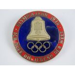 A WWII German 1936 Olympic badge having blue and red enamel to front, enamel slightly a/f,