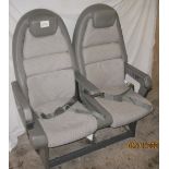 A pair of Concorde passenger seats made by Britax in grey upholstery with leather trim and folding