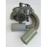 A US Navy issue gas mask having hose and