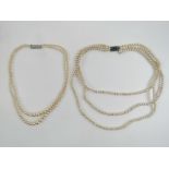 A triple strand faux pearl necklace and