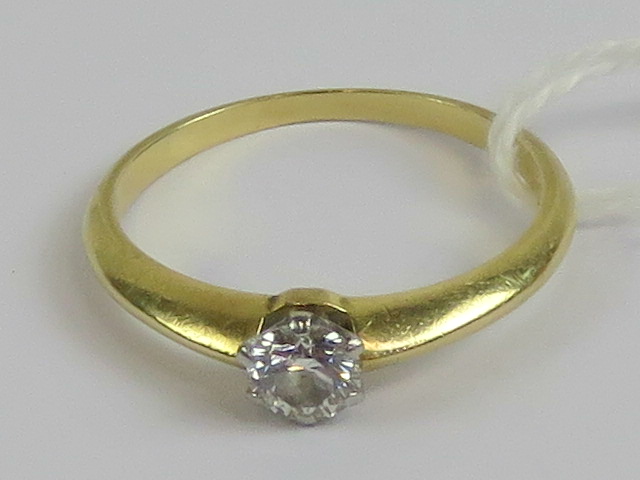 An 18ct gold diamond solitaire ring, the
