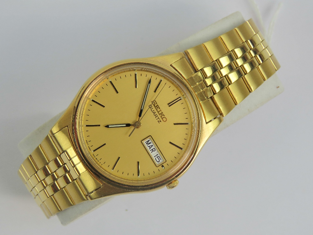 A gold plated Seiko with day and date ap