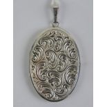 A 925 silver locket of oval form with fl