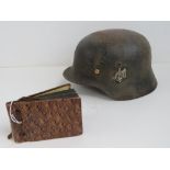 A WWII German helmet having partial decal upon, with liner.