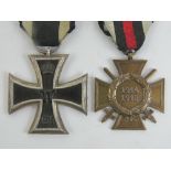 A WWI German Iron cross 2nd Class with ribbon and a 1914-18 cross with swords.