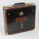 A superb green crocodile skin and leather dispatch box having military insignia upon,