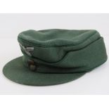 A WWII German Forestry Officials M43 peaked cap with badge upon.