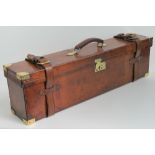 An unusual double depth leather covered 12 gauge twin gun case having two overstraps,