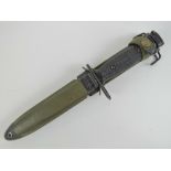 A US Vietnam War M16 bayonet with sheath and canvas frog.