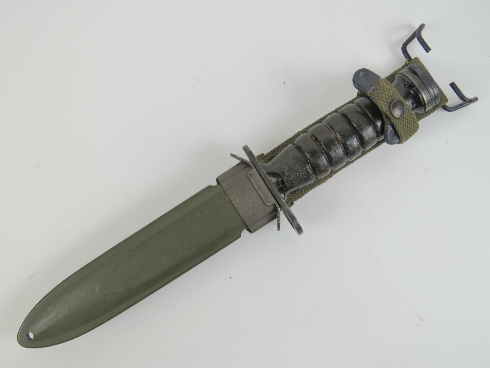 A WWII US M1 Carbine bayonet with scabbard and canvas frog.