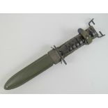 A WWII US M1 Carbine bayonet with scabbard and canvas frog.