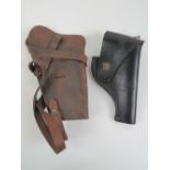 Two reproduction leather holsters; A U.S. Smith And Wesson .