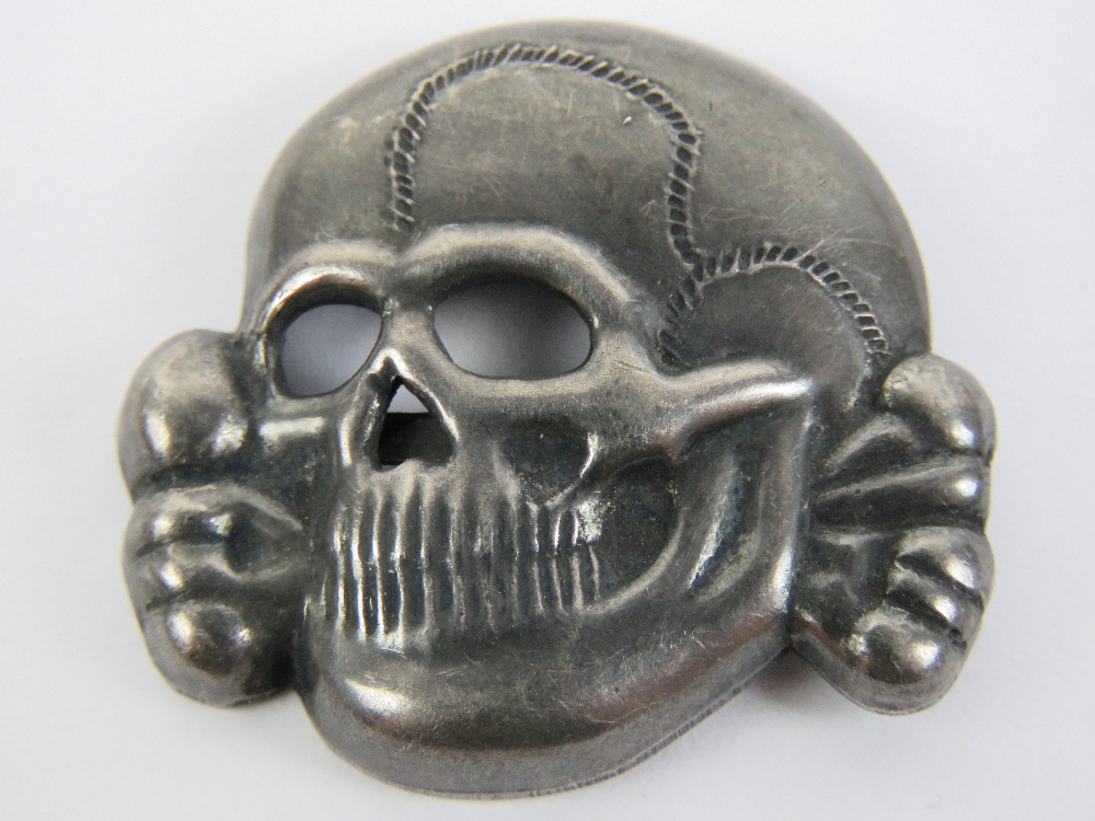 A WWII German SS skull badge for peaked cap, having RZN M1/52 makers mark.