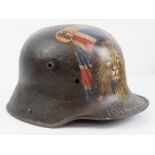 A WWI German M16 helmet having later 'trench art' upon of Union Jack and a Lion.
