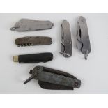 A large folding knife with blade and opposing spike, together with five other knives. Six items.