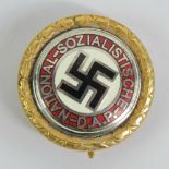 A gilt brass pin badge bearing German NSDAP enamelled logo,