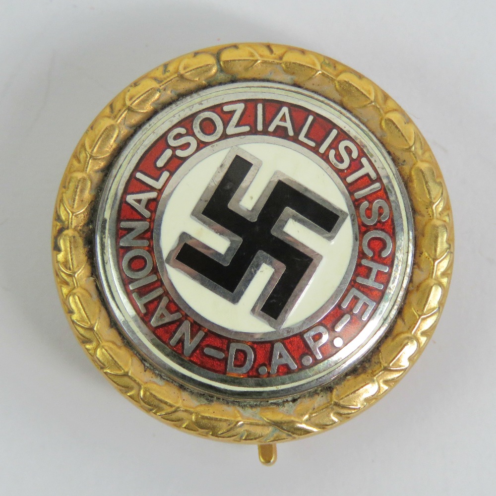 A gilt brass pin badge bearing German NS