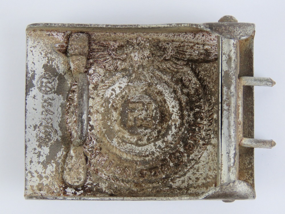 A WWII German SS belt buckle together with two SS Totenkopf skull cap badges. - Image 3 of 5