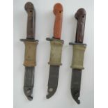 Three Romanian AKM bayonets, each having scabbard and frog,