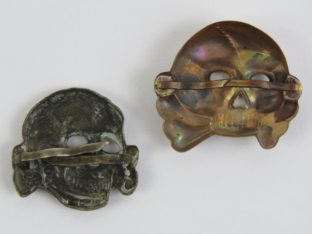 A WWII German SS belt buckle together with two SS Totenkopf skull cap badges. - Image 5 of 5