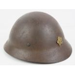 A rare WWII Japanese Police helmet with liner and chin strap, Japanese writing within.