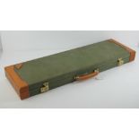 A Browning canvas and leather hinged shotgun travel case, opening to reveal four choke holder,