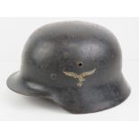 A WWII German M40 Luftwaffe combat helmet having two decals, liner and chin strap.