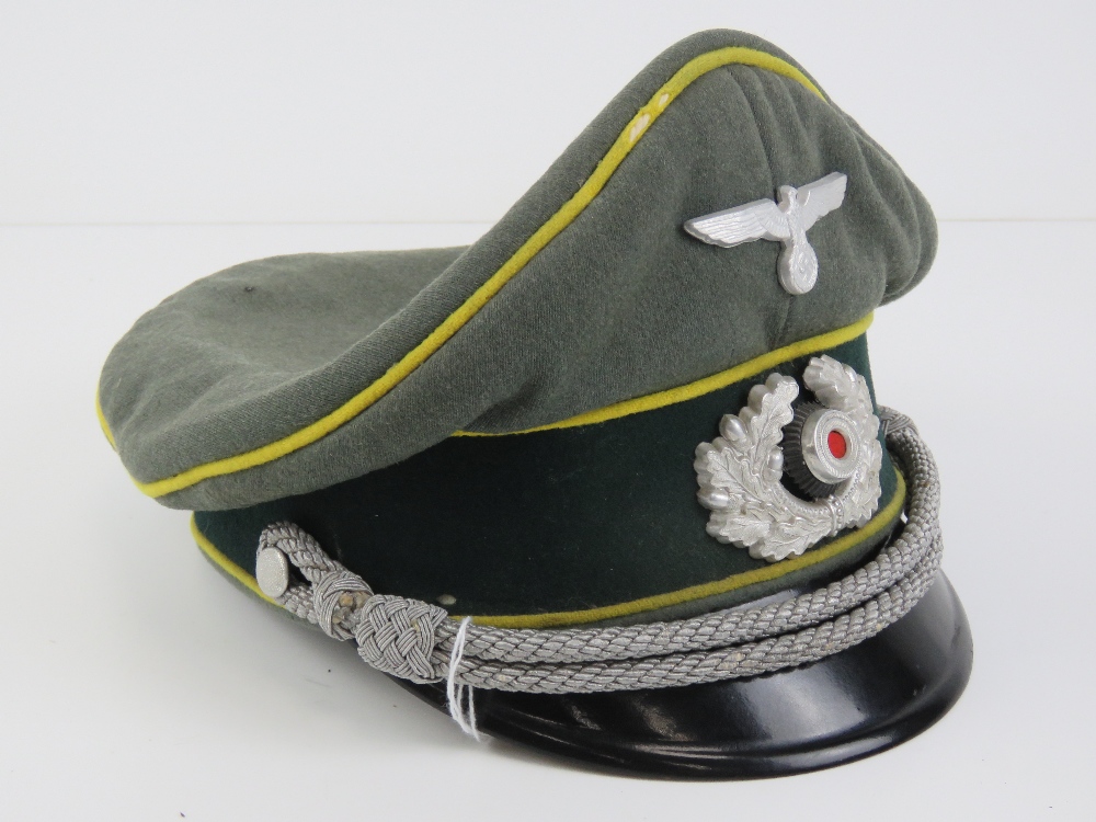 A WWII German Signals peaked cap having makers mark Schellengerg.