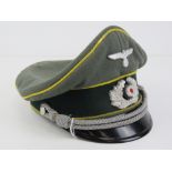 A WWII German Signals peaked cap having makers mark Schellengerg.