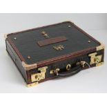 A superb green crocodile skin and leather dispatch box having military insignia upon,