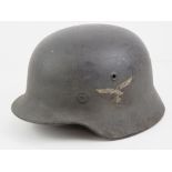 A WWII German M40 Luftwaffe combat helmet having two decals, liner and chin strap.