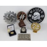Seven assorted reproduction WWII German items.