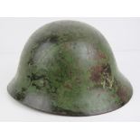 A WWII Japanese Pacific Marine helmet with canvas lining, later added British chin strap.