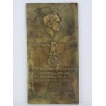 A heavy brass wall plaque 'Berlin 1939' measuring 29.5 x 15cm.