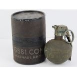 A US MIlitary Vietnam War M67 'Baseball' grenade dated 1973, in original stores pot.