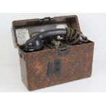 A WWII German field telephone in bakelite case.